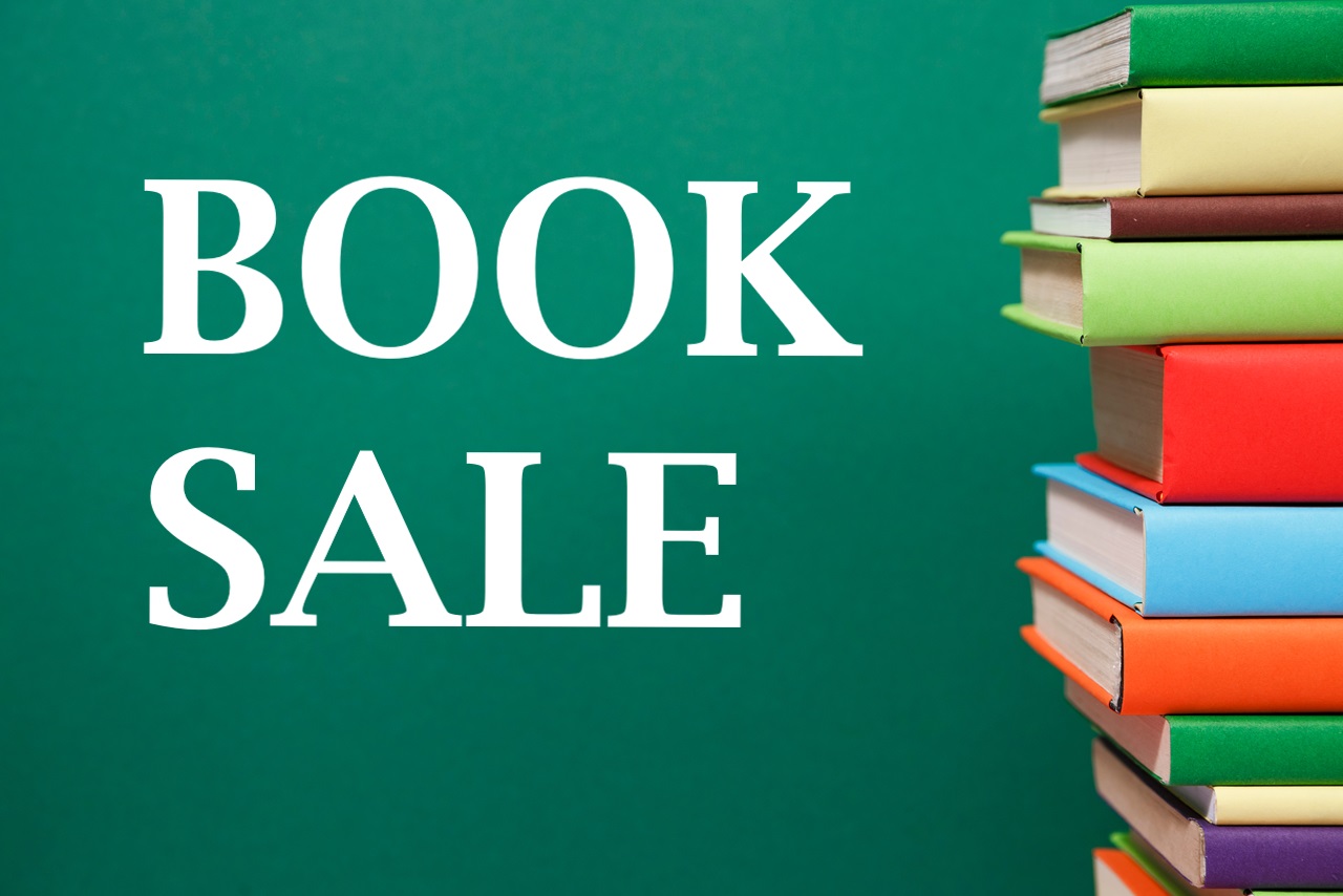 Stack of books sitting on the right of a aquamarine background with the words Book Sale in large white letters.