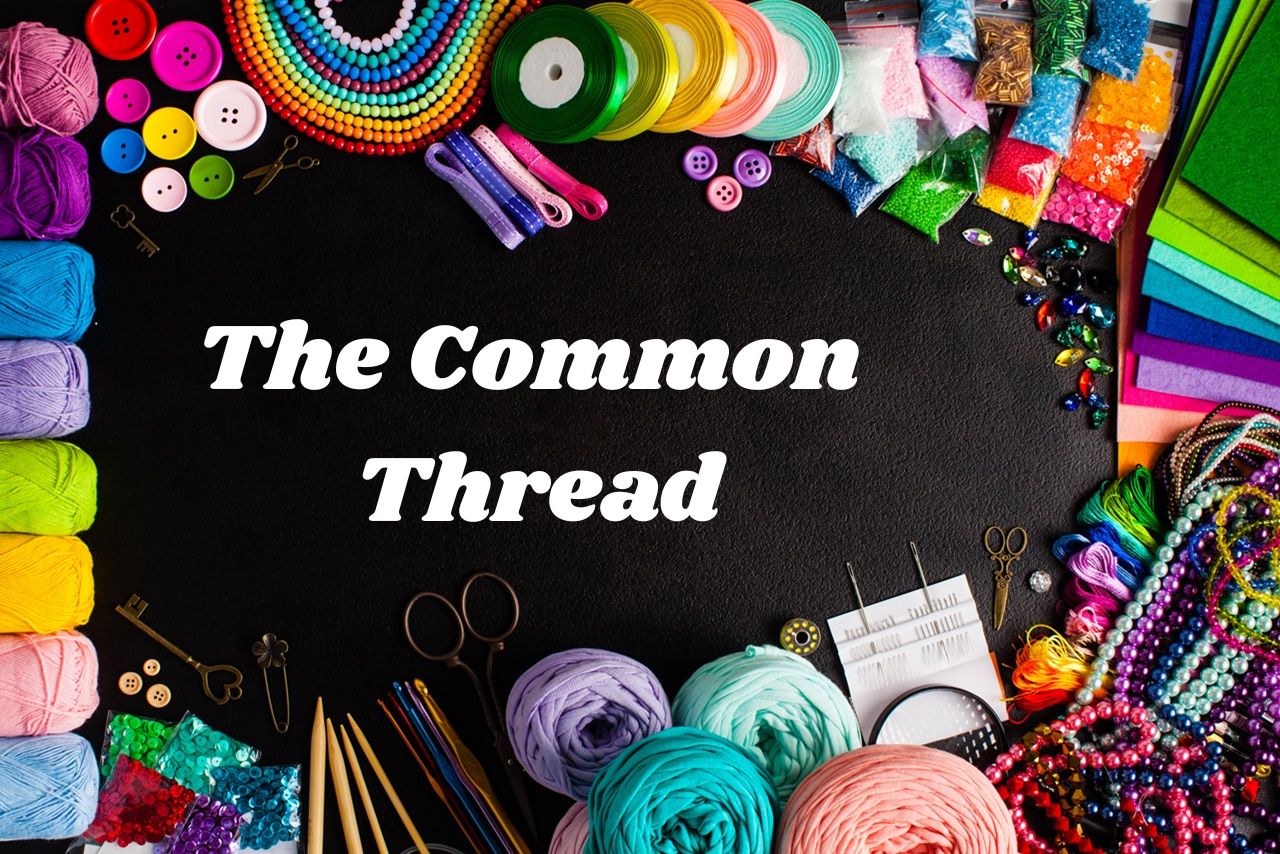 Blackboard that says "The Common Thread" with craft supplies surrounding the edge of the blackboard.
