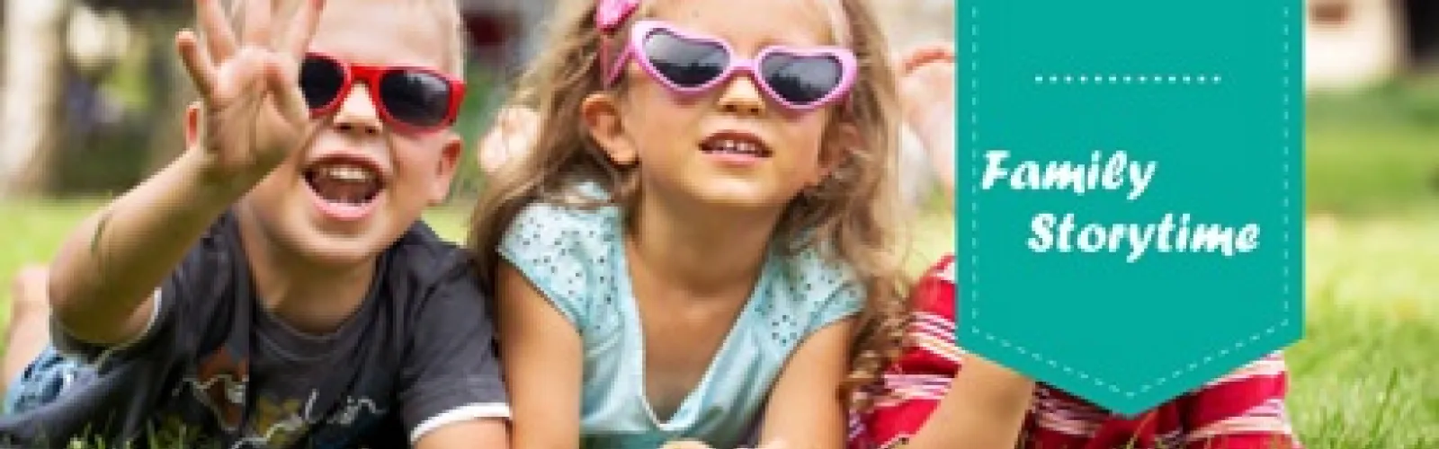 Children lying on the grass wearing sunglasses.