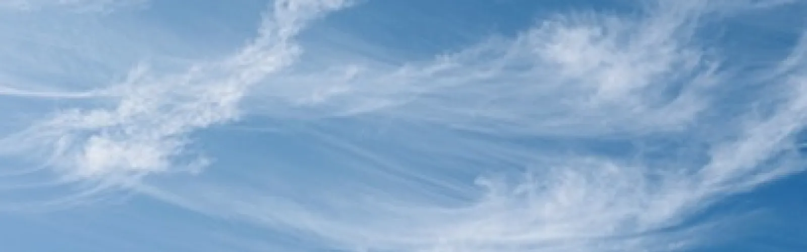 Wispy cirrus clouds in a blue sky.
