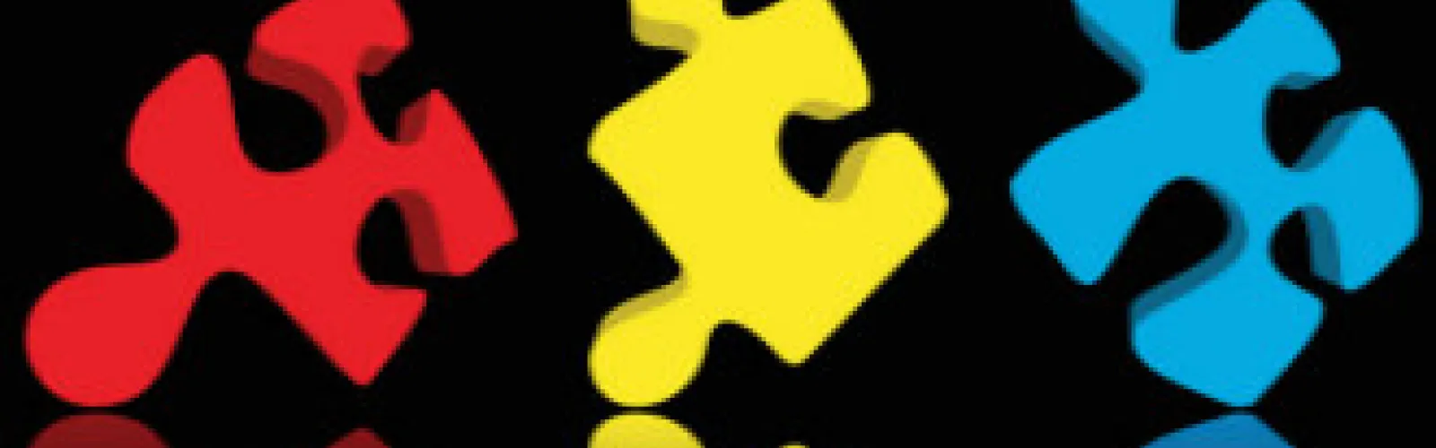 red, yellow, and blue puzzle pieces on a dark background